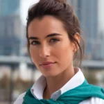 A beautiful woman with a half-up top knot hairstyle.