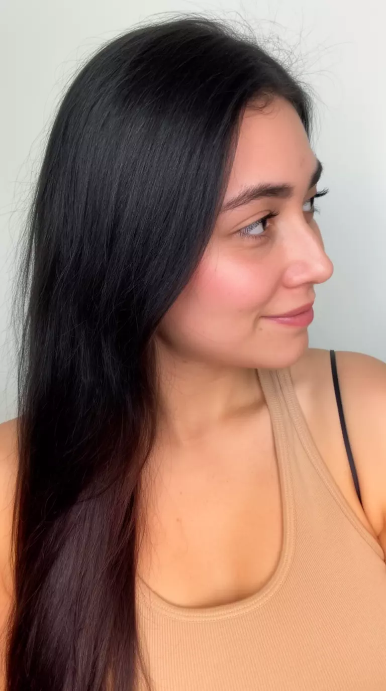 casual close-up photo of a 32-year-old woman wearing a beige tank top with a Cool Tone Whisper Brunette colored long dark hairstyle, side profile view, minimal background