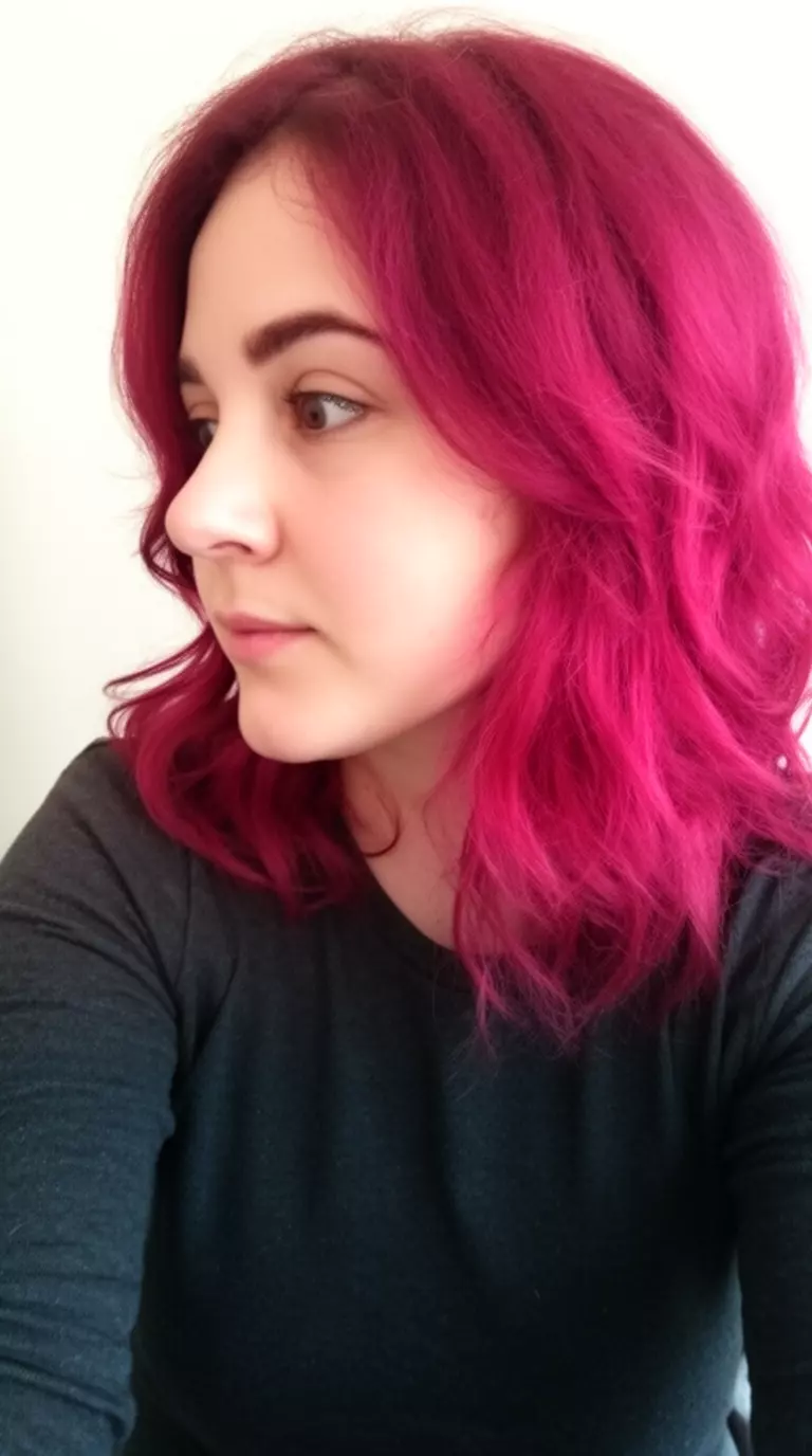 casual close-up photo of a 26-year-old woman wearing a dark long-sleeved top with a magenta colored medium-length wavy hairstyle, profile view, minimal background