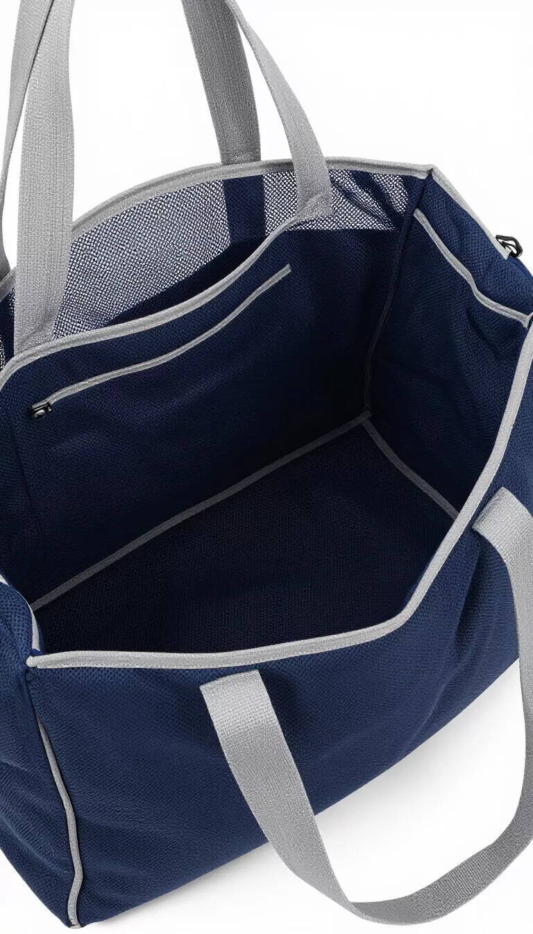 A large navy blue mesh beach bag with gray trim and gray shoulder straps, showing its spacious interior through the mesh fabric.
