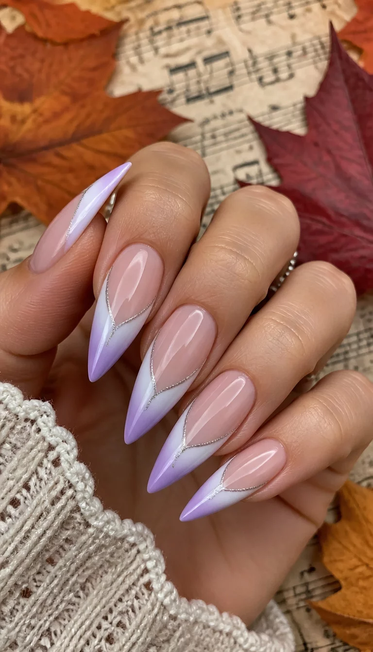 close-up shot of a woman’s hand with five fingers showing long stiletto-shaped nails with a gradient French tip transitioning from white to a soft lavender, accented with silver glitter lines, sheet music and autumn leaves background.