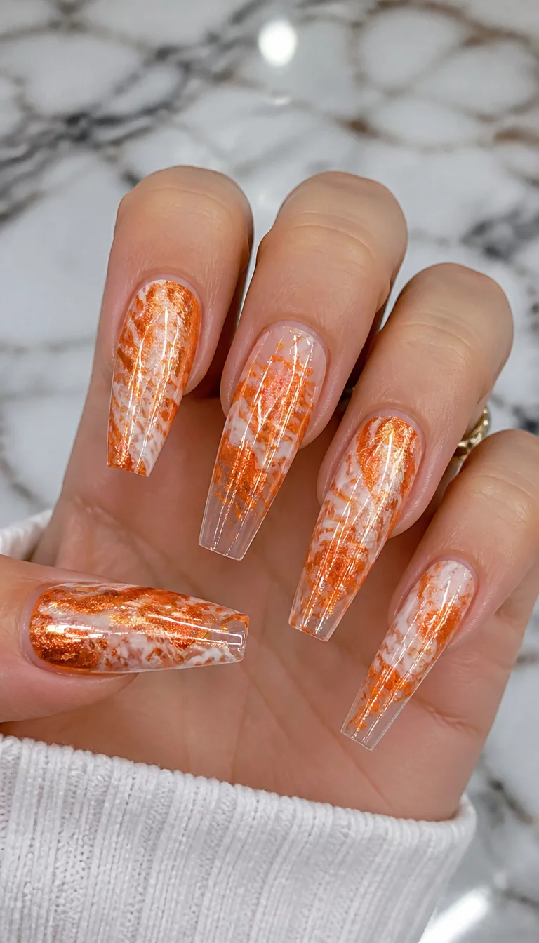 close-up shot of a woman’s hand with five fingers showing long, coffin-shaped nails with a metallic orange and white marbled design, some nails with clear tips, marble countertop background.