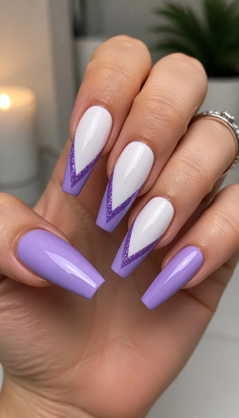 Modern Purple V Shape French close-up shot of a woman’s hand with five fingers showing nails with coffin-shaped nails designed with a white base and a purple V-shaped accent with glitter and solid lavender nails, indoor lighting.