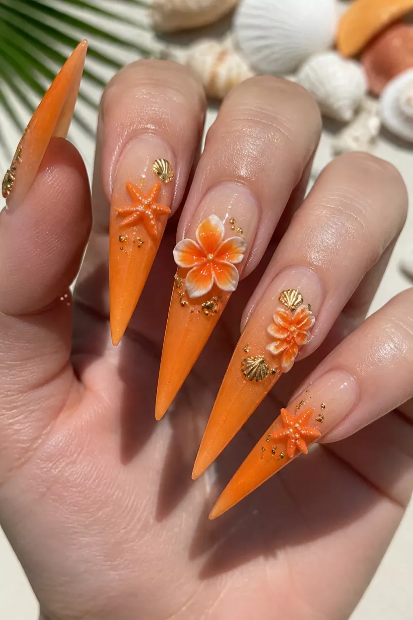 Tropical 3D Sharpness close-up shot of a woman’s hand with five fingers showing nails with long, extremely sharp stiletto nails feature a vivid orange ombré fading into a sheer base, with 3D tropical flower and starfish embellishments.